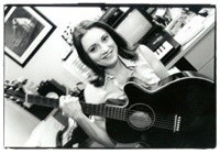 Suzanne holding a guitar
