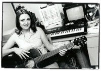 Suzanne holding a guitar